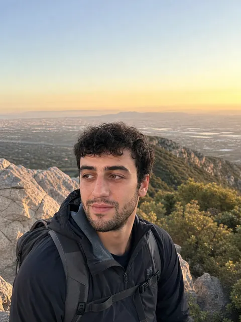 Demo profile opener: golden-hour headshot on a mountain trail