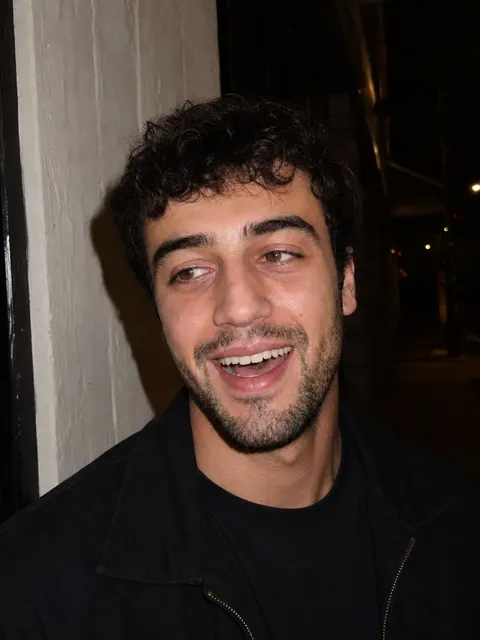 Demo profile candid: laughing three-quarter shot at night